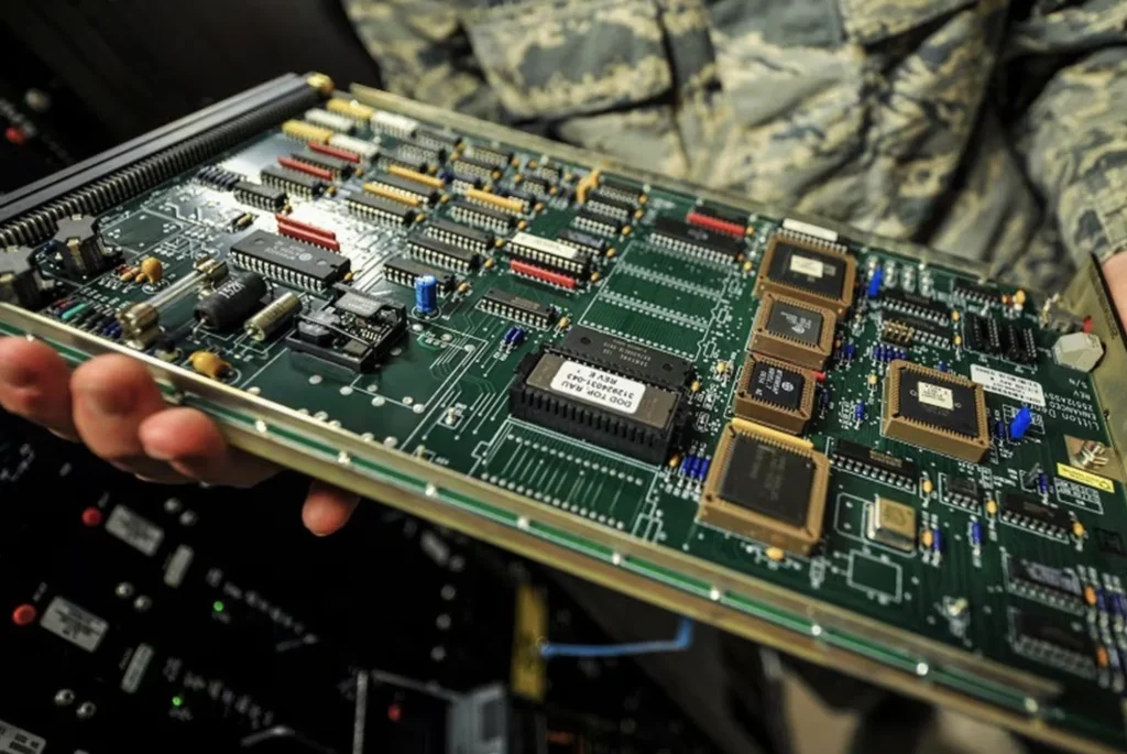 Engineer holding a military-grade satellite PCB control board